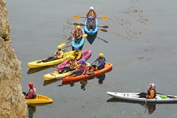 GUIDED TOUR:  A group of kayakers is given instruction about the dos and don&rsquo;ts of entering the caves in the waters below the park. - PHOTO BY GLEN STARKEY