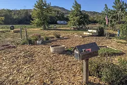 FARM TO TABLE: Some picnic tables near an herb garden make for a good place to enjoy an apple. - PHOTO BY TREVER DIAS
