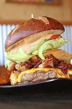 MODERATION IS KEY: Don’t deprive yourself, but do take good care of your gut. Make room for a burger (like this behemoth at Flavor Factory in Morro Bay) on occasion, and enjoy every mouthful. - FILE PHOTO BY HAYLEY THOMAS CAIN