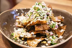 LIKE NO OTHER: Nachos are elevated by rich duck meat and sharp, crumbly feta cheese. - PHOTO BY DYLAN HONEA-BAUMANN