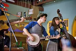 GATHERING PALS: Locals chill out, dance, and watch little kids frolic about the dance floor at a recent happening combining art, music, and food at Sally Loo’s Wholesome Cafe. - PHOTO BY JEN MANUELE