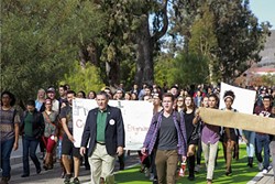NO PLACE FOR HATE:  Cal Poly President Jeffrey Armstrong (left) and junior Matt Klepfer lead a march through campus in December after a SLO Solidarity leader received a death threat from a peer. - PHOTO COURTESY OF CAL POLY