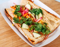 BAHN MI SO HUNGRY:  Pork belly is caramelized on the grill and tucked into a crispy bahn mi sandwich with carrot, cucumber, jalape&ntilde;o, and creamy cilantro aioli. - PHOTO COURTESY OF RICHARD FUSILLO