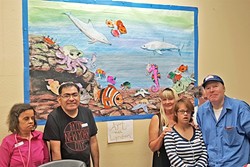 TIME FOR ART:  Lyndon Schaeffer&rsquo;s students stand in front of a whimsical seascape they worked on together. - PHOTO COURTESY OF LYNDON SCHAEFFER