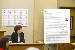 READ ALL ABOUT IT: Karen Velie, journalist and owner of CalCoastNews, examines the article she co-wrote with reporter Dan Blackburn in 2012, which sparked a libel lawsuit. - PHOTO BY JAYSON MELLOM
