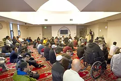 FAITH: Men who attend prayer at the Mosque of Nasreen sit in the front room of the Mosque while women watch prayer from a separate room. - PHOTO BY JAYSON MELLOM