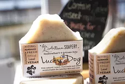 GIVE FIDO A BATH: Katye Fredieu of Artisan Soapery wants everyone nice and squeaky clean, even the fur babies. The Lucky Dog soap contains milk thistle to give your pup a shiny coat. - PHOTO BY JAYSON MELLOM