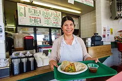 EVERYDAY IS FOR TACOS: Juana Peliego serves up a burrito with a smile at Tacos de Mexico in Morro Bay. The downtown establishment also gets a win for best tacos, which aren’t just for Tuesdays. - PHOTO BY JAYSON MELLOM