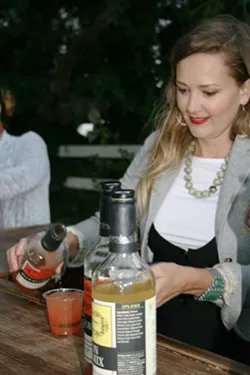 HIGH SPIRITS THC-infused sparkling water mixed with blood orange juice feels a lot like your typical cocktail in your hand, but it should be consumed differently than alcohol. Pictured, Amanda Valena of Megan's Organic Market. - PHOTO BY HAYLEY THOMAS CAIN