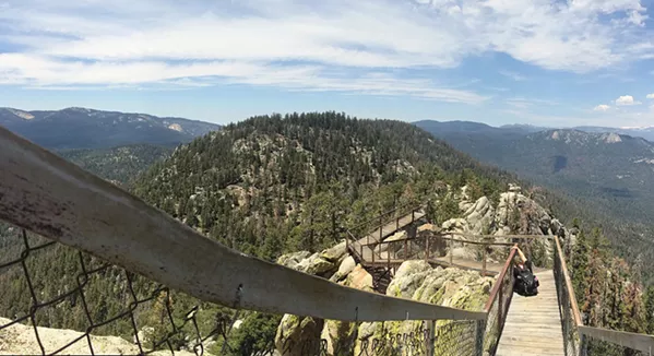 SITTING ON TOP A surreal set of wooden steps take hikers from solid ground to suspended above a granite rock face looking out over the Sequoia National Forest. - PHOTO BY CAMILLIA LANHAM