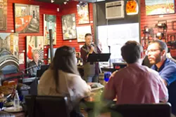 THE JOY OF SONG Grant Crowl, the teacher behind Cuesta College's cabaret class and the group Cabaret 805, sings a tune at Stax Wine Bar in Morro Bay. - PHOTO BY JAYSON MELLOM