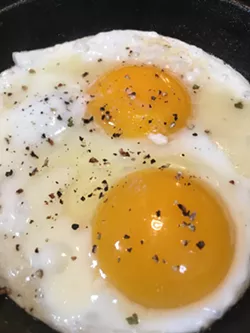 WAKEY WAKEY At Cain's house, a mini cast iron skillet—the perfect size for frying two eggs—sizzles with butter and fresh cracked black pepper. - PHOTOS BY HAYLEY THOMAS CAIN