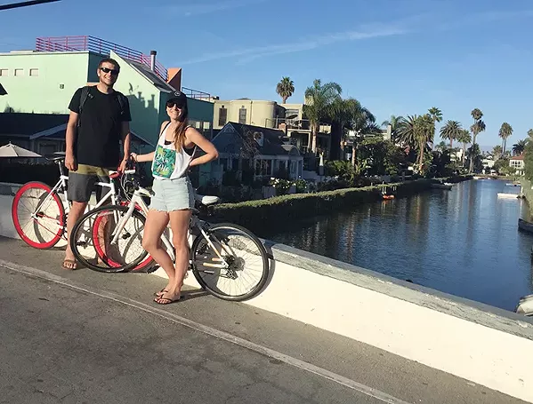 BRO AND SIS My sister, Lisa, and I stop our bikes for a quick photo next to the Venice canals. - PHOTO COURTESY OF JOHN STEIN