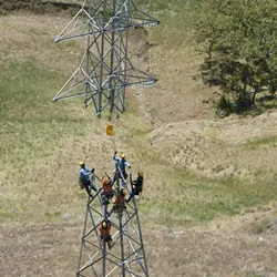 COMMUNITY ENERGY PG&E crews work on a local transmission line in 2013. A Community Choice Energy program pursued by SLO would use existing infrastructure to distribute power. - FILE PHOTO