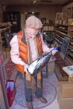 ONE OF A KIND Archie McLaren holds an oversized bottle of wine made especially for him by local winemakers, many of whom have participated in the Central Coast Wine Classic, for his 40th birthday years ago. - PHOTO BY JAYSON MELLOM