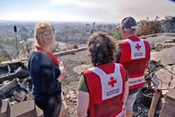 GONE Linda Allen stands with Red Cross volunteers as she looks at the remainder of her home in Ventura's Skyline neighborhood. - PHOTO BY DERMOT TATLOW COURTESY OF THE RED CROSS