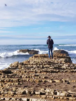 TAKING IT IN Sitting on the beach, we saw many people walking toward the edge of the rocks taking photos and selfies of their day. - PHOTO BY KAREN GARCIA
