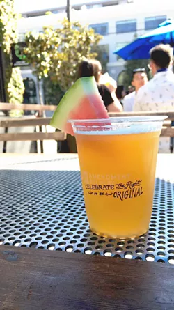 CHEERS TO A COLD ONE 21st Amendment Brewery's newest sour ale, Watermelon Funk, is tastefully served with a slice of watermelon on the rim of my cup. - PHOTO BY KAREN GARCIA