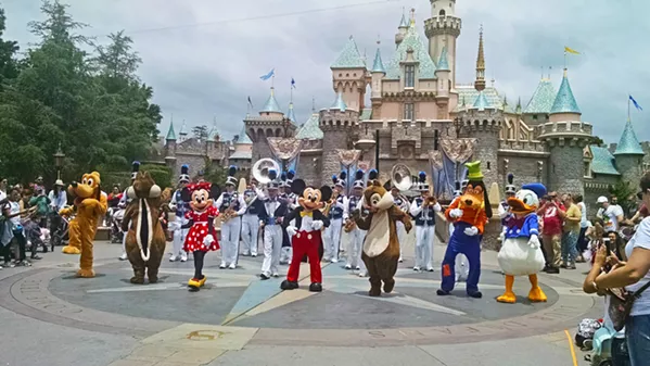 THE GANG'S ALL HERE Mickey, Minnie, Donald, Goofy, Pluto, Chip, and Dale dance their tails off in front of the Sleeping Beauty Castle. - PHOTO BY CALEB WISEBLOOD