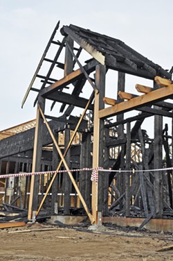 HOUSING IN ASHES In April 2016, one of seven homes being built to house H-2A farmworkers in Nipomo was burned down by an arsonist who's still at large. The development received intense opposition from neighbors and highlighted the struggle in SLO County to accommodate a growing population of foreign field laborers who need housing. - FILE PHOTO BY CAMILLIA LANHAM