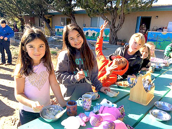 FOOD AND FUN Santa Lucia School students enjoy their lunch and play outside. - PHOTO COURTESY OF STACY BURK