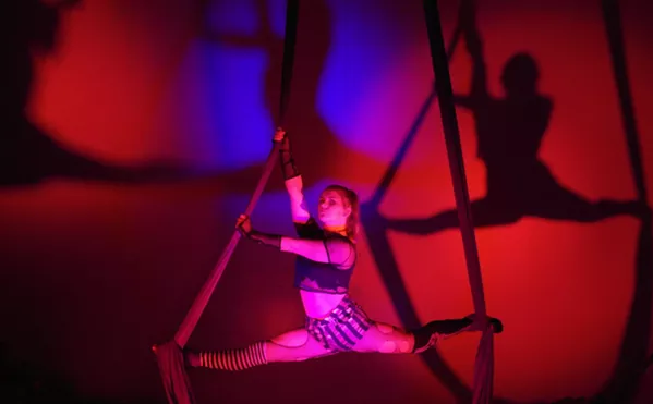 SEEING DOUBLE Aerialist Cheyenne Miller holds the splits on the aerial silks in preparation for the upcoming Halloween show, Welcome Stranger, at Levity Academy in SLO. - PHOTO COURTESY OF LEVITY ACADEMY