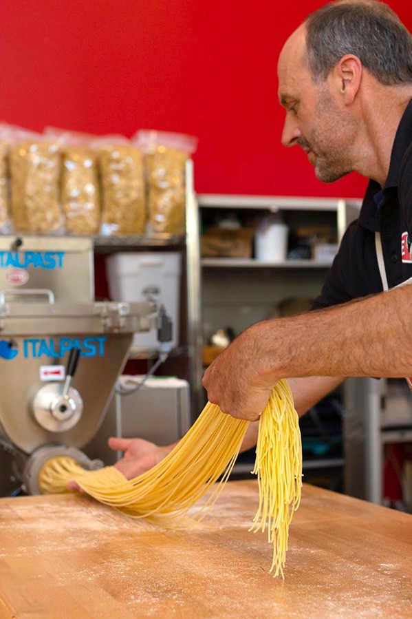 FLOUR ON HIS HANDS Lloyd Herrera guides freshly made linguine through a state-of-the art imported Italian pasta machine at Etto in Paso Robles' Tin City. - PHOTO COURTESY OF LEILA SAPPA