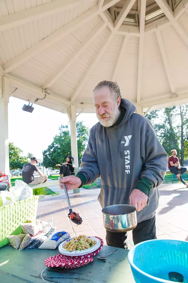 LOCAL LAWS SLO city does not have an ordinance that bans feeding the homeless in public places, but other laws against overnight vehicle camping, sitting on public benches for too long, and panhandling in public often impact the city's homeless population. - PHOTO BY JAYSON MELLOM