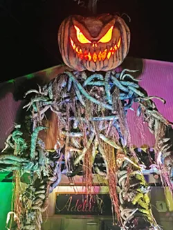PUMPKIN OVERLORD A face you will never forget welcomes costumed revelers to the Halloween Ball. - PHOTO BY CAMILLIA LANHAM