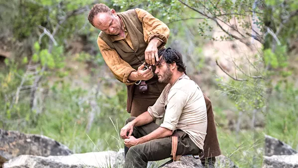 BROTHER'S KEEPER Eli Sisters (John C. Reilly, standing) seems to always be keeping his reckless younger brother, Charlie (Joaquin Phoenix), out of trouble. - PHOTO COURTESY OF ANNAPURNA PICTURES