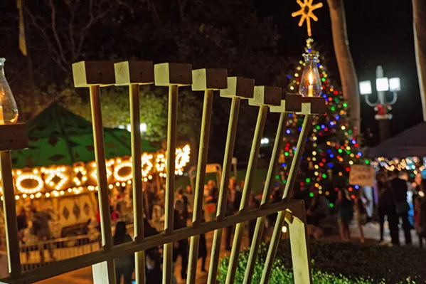 EIGHT NIGHTS OF OIL The first candle on the menorah shines bright in SLO's Mission Plaza in December 2017 on the first night of Hanukkah. - PHOTOS COURTESY OF THE JCC OF SLO
