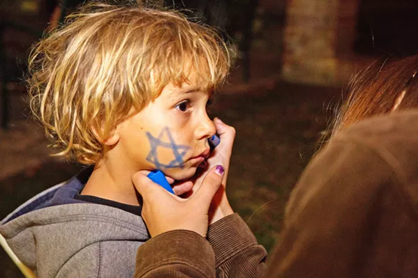 STAR A young child gets a Star of David drawn on his cheek on the first night of Hanukkah in 2017. - PHOTOS COURTESY OF THE JCC OF SLO