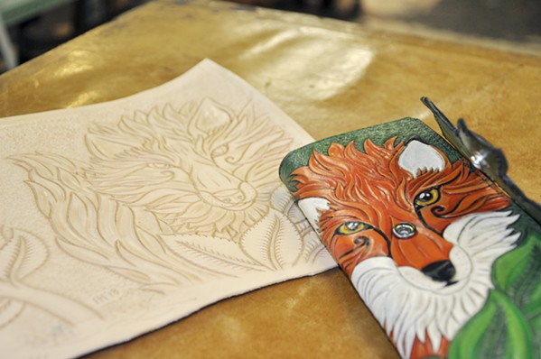 FOXY LADY The Leather Shop owner and leathersmith Finn Hansen stamps, paints, and cuts images such as a fox and fern into leather to make women's wallets, journals, coin purses, and more. - PHOTO BY CAMILLIA LANHAM