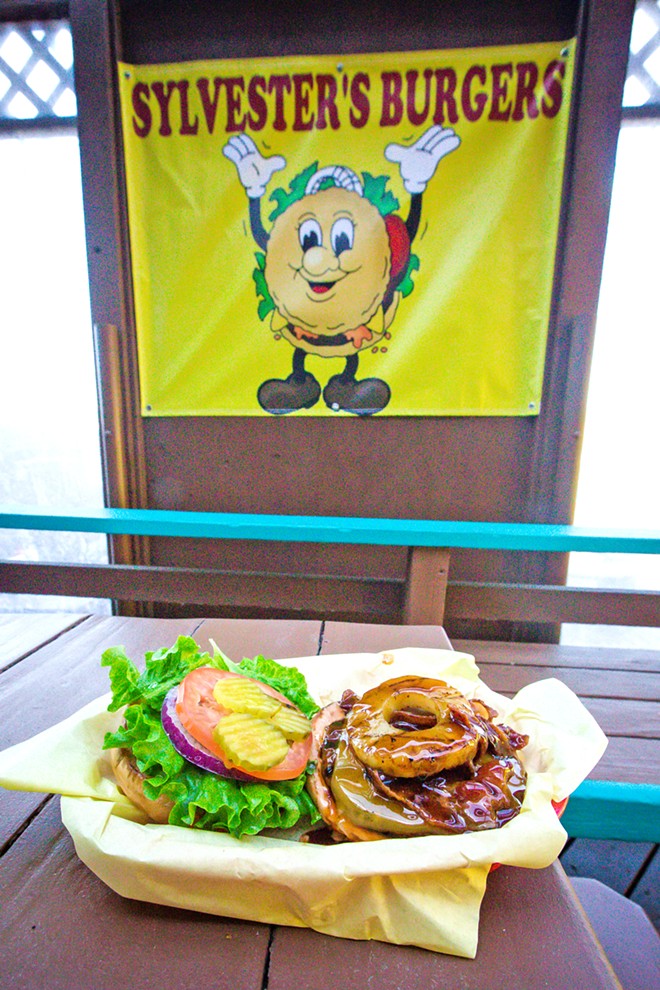 DIRTY BURGER There’s something about a burger from Sylvester’s that makes you want to stick your elbows on the table and lick sauce off your arms. This Hana Burger, with grilled pineapple is no exception. - PHOTO BY JAYSON MELLOM
