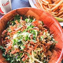 LUNCH RUSH Sidewalk Café's Asian chicken salad comes with cabbage, carrots, green onions, cilantro, almonds, and chicken and is tossed in a sesame ginger dressing and topped with crispy wonton strips. - PHOTOS COURTESY OF KACEY COLLINS