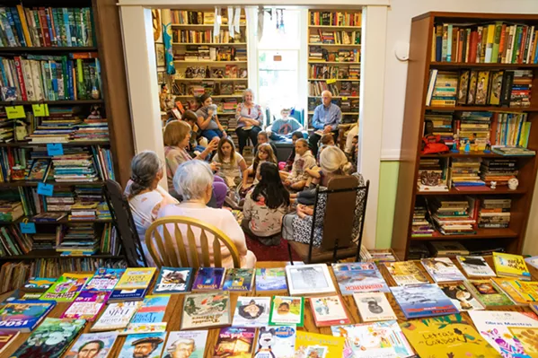 GIFTING BOOKS Liz Krieger has opened her home to schools, teachers, and, most importantly, students in order to give away donated books. - PHOTOS BY JAYSON MELLOM