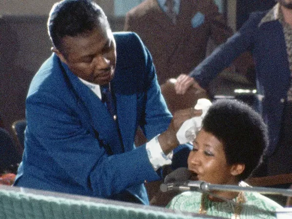 DIVINE As Aretha Franklin sings, her father, Rev. C.L. Franklin, wipes the perspiration from her face in this moving concert documentary filmed in 1972. - PHOTOS COURTESY OF 40 ACRES & A MULE FILMWORKS