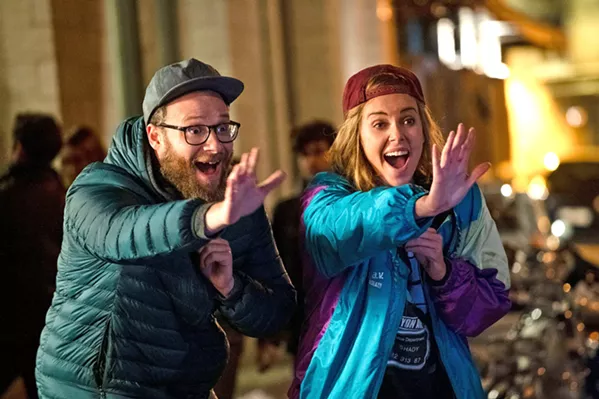 PARTY Frumpy journalist Fred Flarsky (Seth Rogen, left), reunites with his first crush—beautiful, ambitious, but lonely presidential hopeful Charlotte Field (Charlize Theron)—who hires him as her speechwriter, in Long Shot. - PHOTO COURTESY OF DENVER AND DELILAH PRODUCTIONS