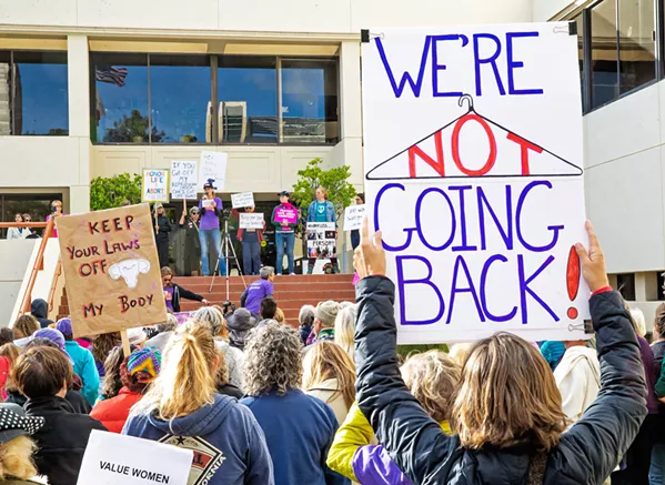 FOR ALL WOMEN Women and men stand together to rally for reproductive rights and access to health care for women of all walks of life during a May 21 rally in SLO. - PHOTO BY JAYSOM MELLOM