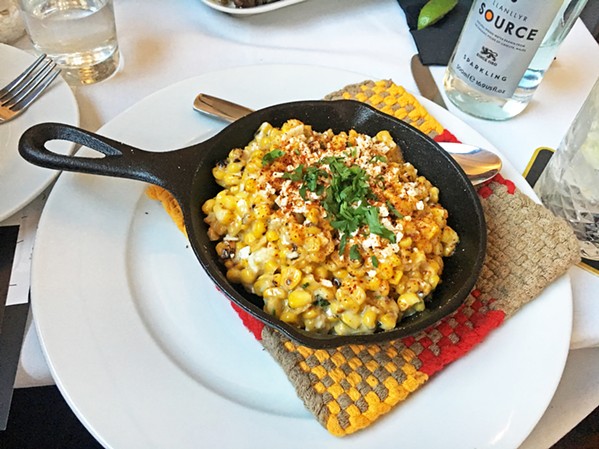 ABUELA'S CREAMED CORN Served in a skillet, the roasted corn off the cob elote side dish will make you rethink eating veggies as a duty. - PHOTOS BY BETH GIUFFRE
