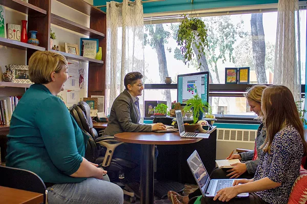 EXPANDING SERVICES Dr. Jay Bettergarcia, a Cal Poly psychology professor (at desk), leads the SLO ACCEPTance Project, a four-year venture that delivers 9-month trainings to local therapists to strengthen their competency with LGBTQ clients. - PHOTO COURTESY OF CAL POLY