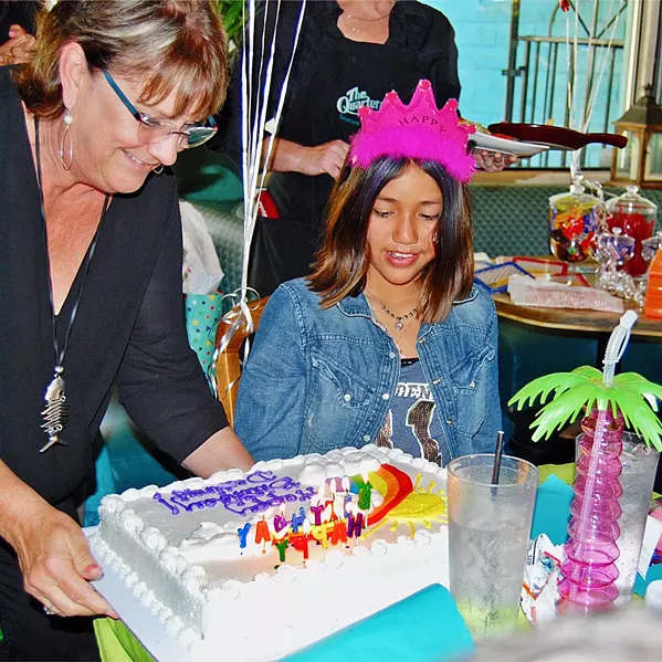 WRAPPED UP HAPPINESS Jeff Edwards celebrated Destiny's (right) 10th birthday, and Quarterdeck Seafood Restaurant owner Cyndy Jones (left) was among the guests. - PHOTO COURTESY OF CANDLES FOR KIDS
