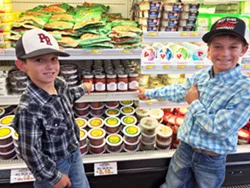 YOUNG ENTREPRENEURS Twisselman boys Taylor, left, and Aidan, right, spot their family's Best Ever Salsa Company jars on the local grocery shelves. Aidan, nicknamed "Salsa Man," loves being part of the family business. - PHOTO COURTESY OF KARLI TWISSELMAN