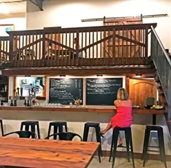 LADY IN RED The new owners re-surfaced the bar, and up on the chalkboards are the daily specials and a list of local wines and drafts, including the Niner chardonnay, Ancient Peaks cab, Central Coast Brewing's Peanut Butter Breakdown, and Tent City Imperial Red Ale. - PHOTO BY BETH GIUFFRE