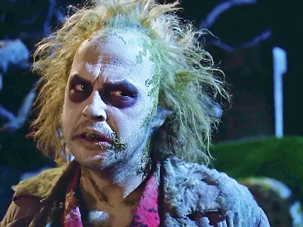 SAY IT THRICE Michael Keaton stars as Betelgeuse, a malicious spirit hired by a recently deceased couple to help them drive an obnoxious family out of their house, in the 1988 Tim Burton horror-comedy classic, Beetlejuice, screening on Oct. 20, in Galaxy Colony Square 10 Theaters. - PHOTO COURTESY OF THE GEFFEN COMPANY