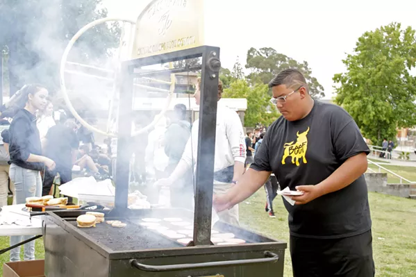 SCHOOL BARBECUE SLO High School Associated Student Body members throw patties on a grill at the school's first Student of the Month Barbecue of the year on Sept. 27. - PHOTO BY KASEY BUBNASH