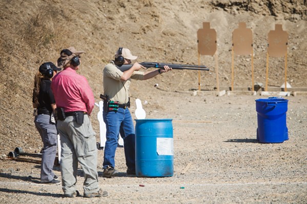 TARGET PRACTICE Instructors accompany a gun club member who's honing his rifle skills on one of SLOSA's 12 ranges. - PHOTO BY JAYSON MELLOM