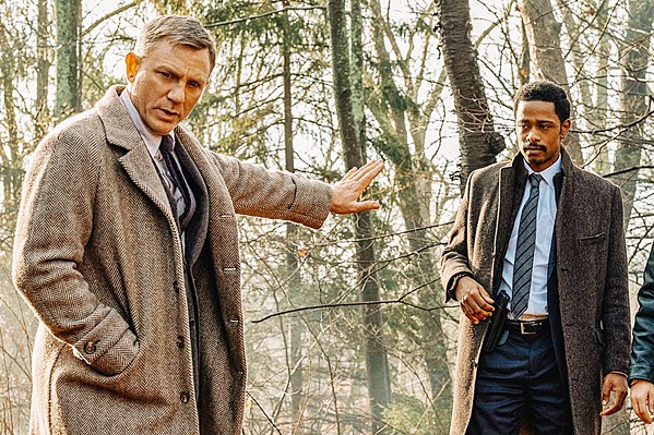 HE'S ON THE CASE Renowned detective Benoit Blanc (Daniel Craig, left) helps Lt. Elliott (LaKeith Stanfield) search for clues to the mystery of crime novelist Harlan Thrombey's death. - PHOTO COURTESY OF LIONSGATE