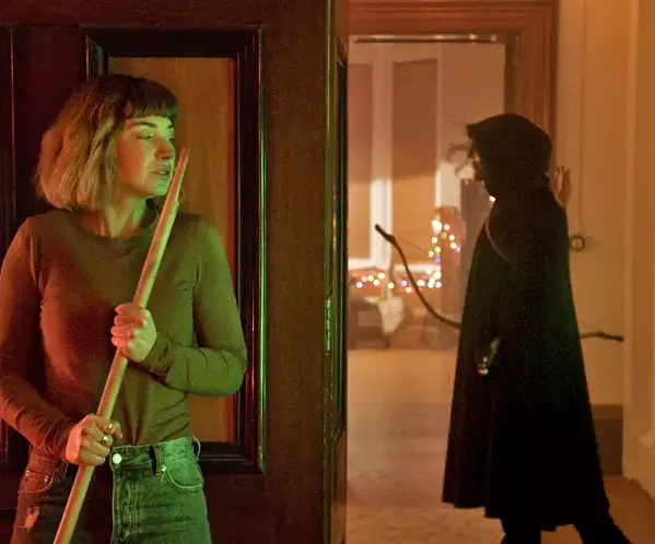 ALL THROUGH THE HOUSE Imogen Poots stars as Riley (left), a college co-ed stalked by a killer over Christmas break, in Black Christmas, screening exclusively at Park Cinemas. - PHOTO COURTESY OF UNIVERSAL PICTURES