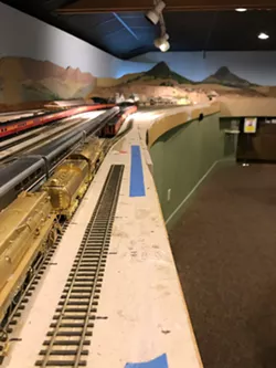 MODEL A model railway sits in the SLO Railroad Museum. Pictured is the train station in SLO—note Bishop Peak and Cerro San Luis in the background. - PHOTOS BY PETER JOHNSON